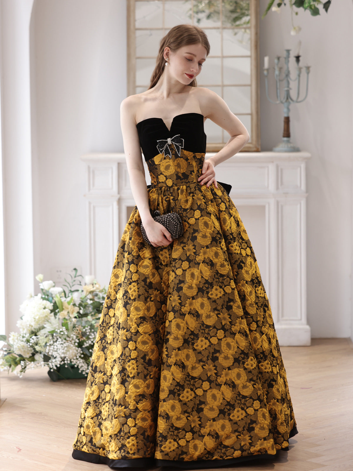 Elegant Black and Gold Floral Strapless Ball Gown with Bow Accent Elegant Black and Gold Floral Strapless Ball Gown with Bow Accent