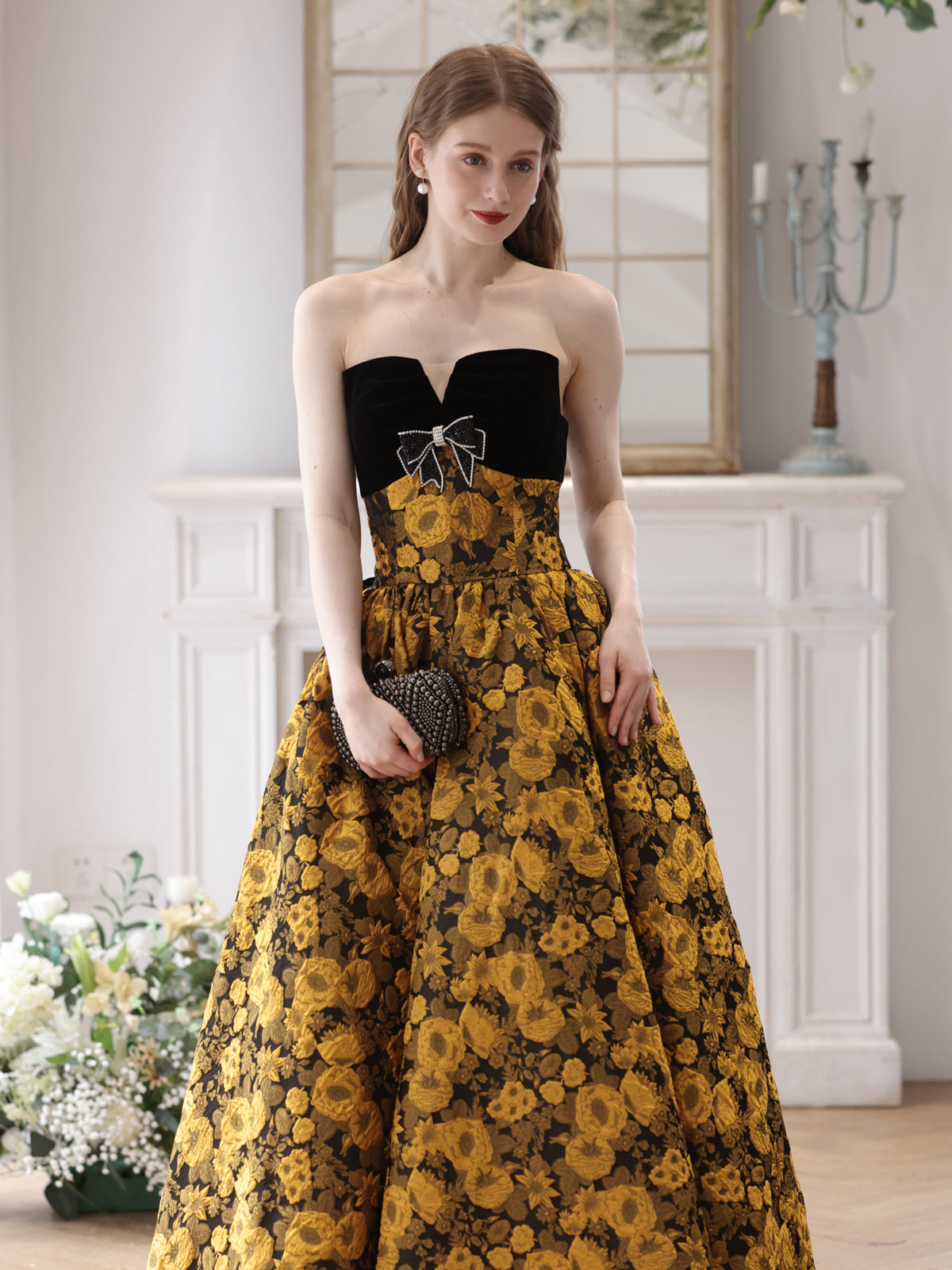 Elegant Black and Gold Floral Strapless Ball Gown with Bow Accent Elegant Black and Gold Floral Strapless Ball Gown with Bow Accent