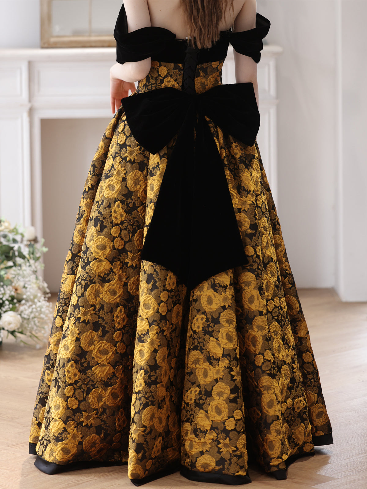 Elegant Black and Gold Floral Strapless Ball Gown with Bow Accent - Harmony Gallery
