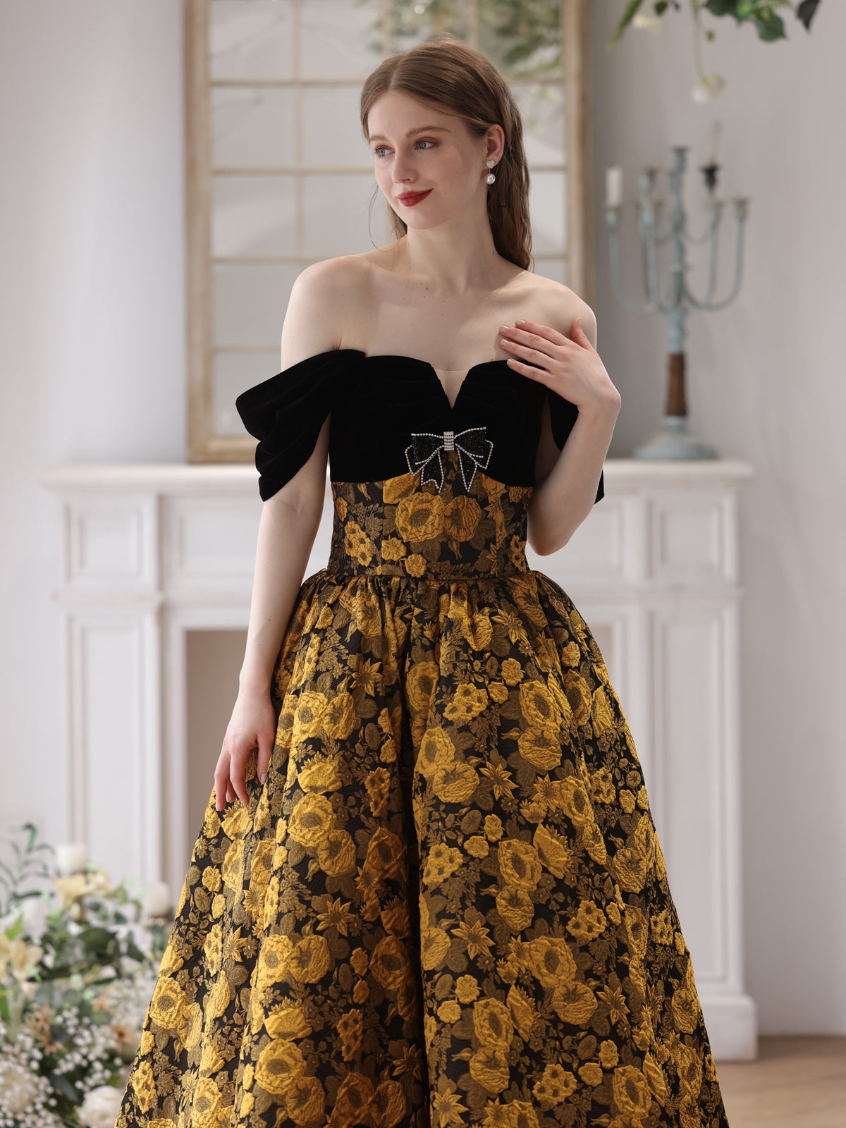 Elegant Black and Gold Floral Strapless Ball Gown with Bow Accent Elegant Black and Gold Floral Strapless Ball Gown with Bow Accent