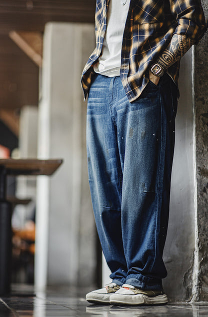 Jeans masculino americano desgastado com bigode de gato branco lavado com respingos de tinta